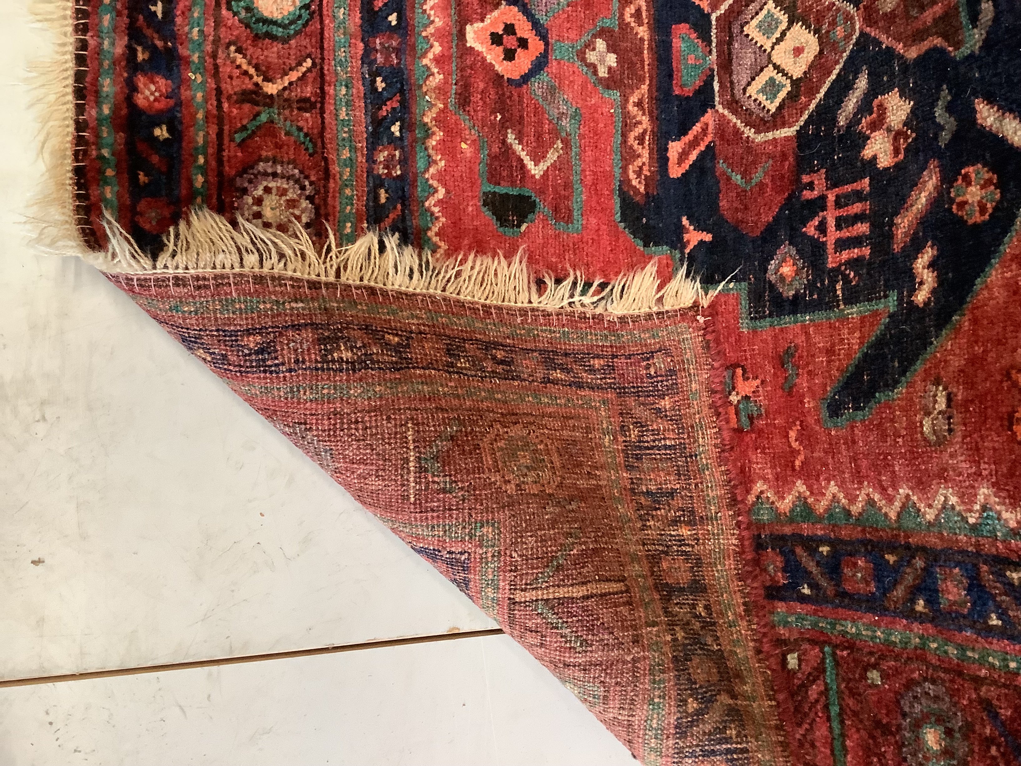 An Heriz red ground medallion rug 280 x 137cm